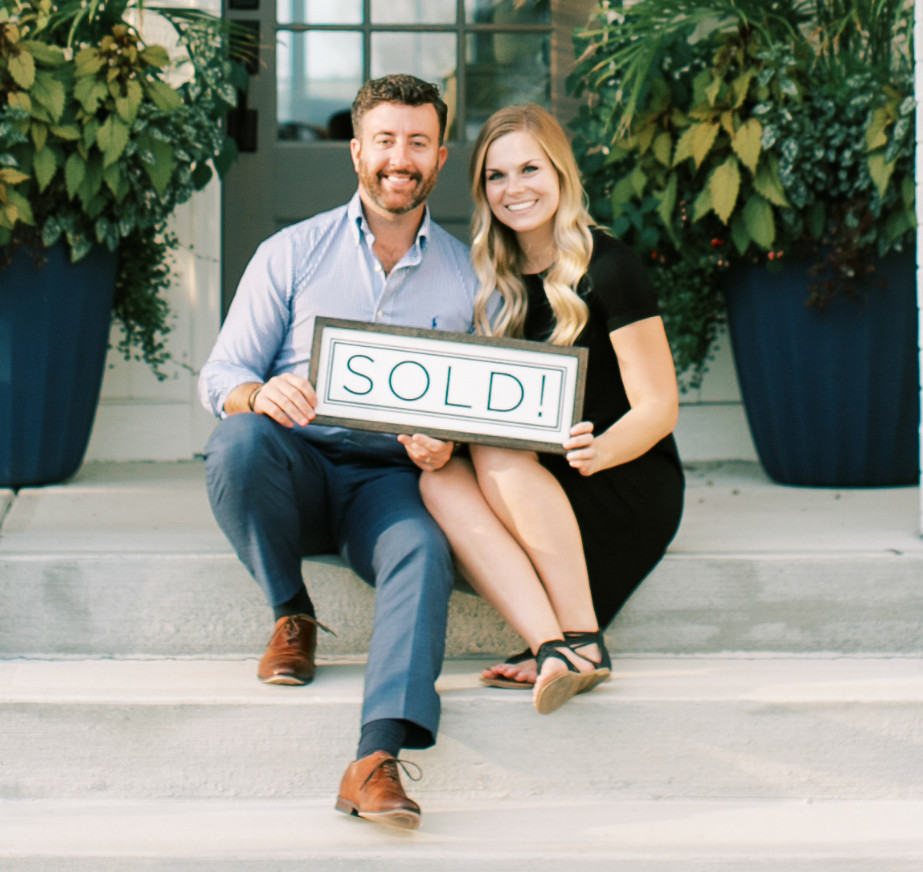 Trent and Maggie with sold sign